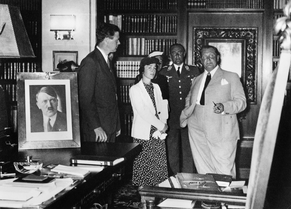 GÖRING AND LINDBERGH, 1936. American aviator Charles Lindbergh left and his wife, Anne, visiting Berlin with Hermann Göring, Commander of the German Luftwaffe. A portrait of Adolf Hitler is on the des ...