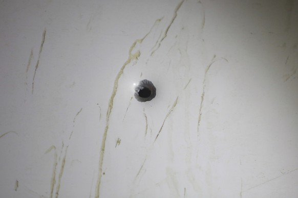 A hole, possibly caused by a bullet, pierces one of the buses used in the campaign caravan of Brazil&#039;s former President Luiz Inacio Lula da Silva, as the bus sits parked at a lot in Laranjeiras d ...