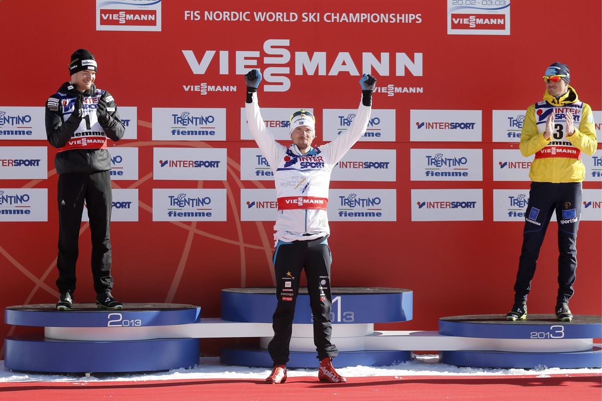 From left: Dario Cologna of Switzerland, Johan Olsson of Sweden and Alexey Poltoranin of Kazakhstan stand on the podium after the men's 50 km classic mass start race at the FIS Nordic Skiing Worl ...