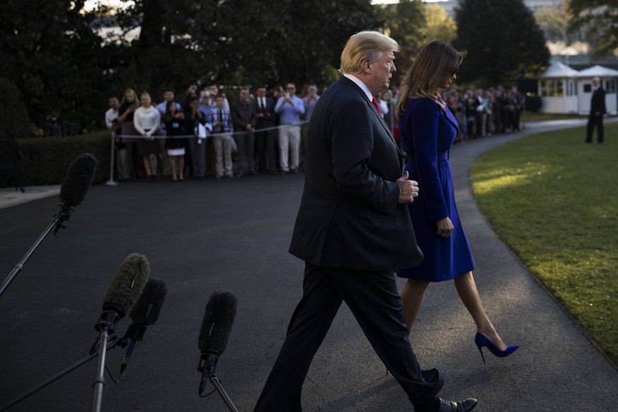 epa06306222 US President Donald J. Trump (L) and First Lady Melania Trump (R) walk to board Marine One on the South Lawn of the White House in Washington, DC, USA, 03 November 2017. President Trump is ...