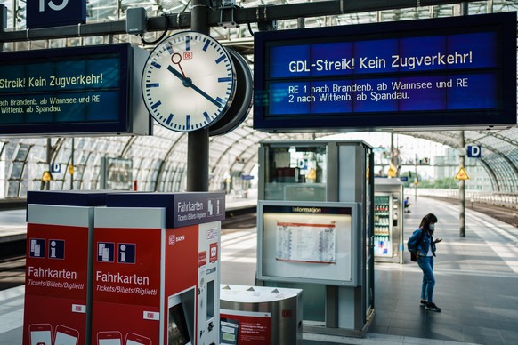 epa09409487 A display reads 'GDL strike - no train service', while a passenger waits on a nearly deserted platform during a warning strike in railway operations in Germany at Berlin Central Railway St ...