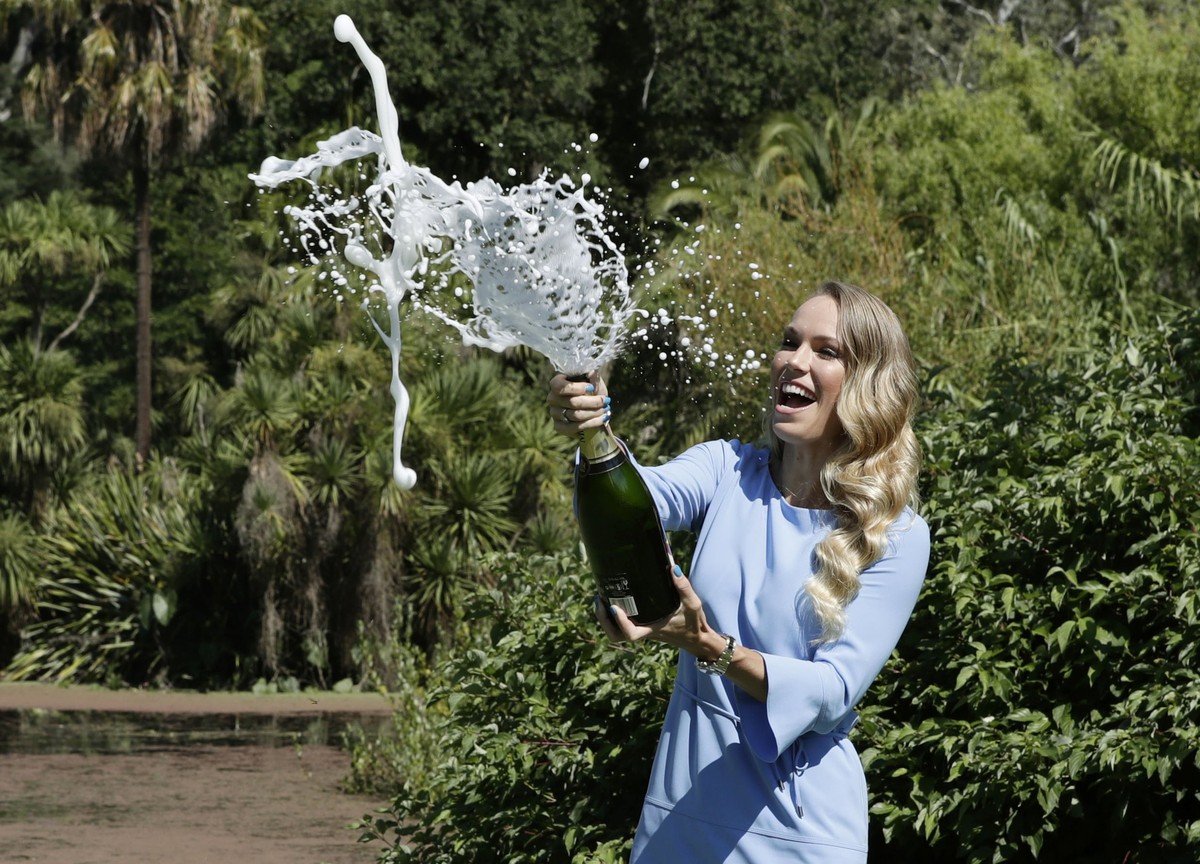epaselect epa06479656 Caroline Wozniacki of Denmark sprays champagne while posing with her trophy for winning the women's final at the Australian Open Grand Slam tennis tournament in Melbourne, A ...