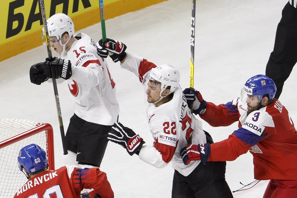 Switzerland's forward Nino Niederreiter #22 celebrates his goal with teammate forward Gregory Hofmann #15 past Czech Republic's defender Michal Moravcik, left, and Czech Republic's defe ...