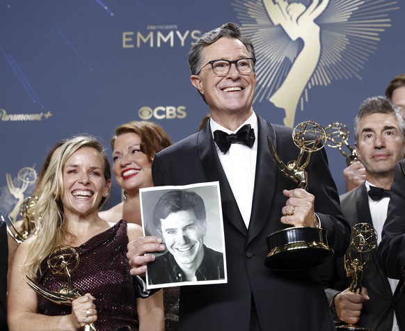 epa12378615 US comedian Stephen Colbert (C) holds a picture as he poses with the Best Talk Show award for &#039;The Late Show With Stephen Colbert,&#039; at the 77th annual Emmy Awards ceremony held a ...