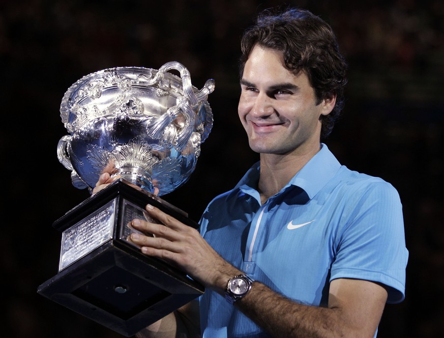 FILE - Roger Federer of Switzerland holds the trophy after beating Andy Murray of Britain to win the Men&#039;s singles final match at the Australian Open tennis championship in Melbourne, Australia,  ...