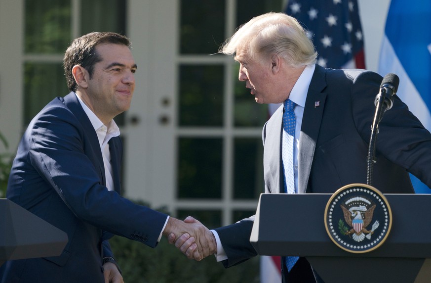 President Donald Trump and Greek Prime Minister Alexis Tsipras shake hands during a news conference in the Rose Garden of the White House in Washington, Tuesday, Oct. 17, 2017. (AP Photo/Carolyn Kaste ...