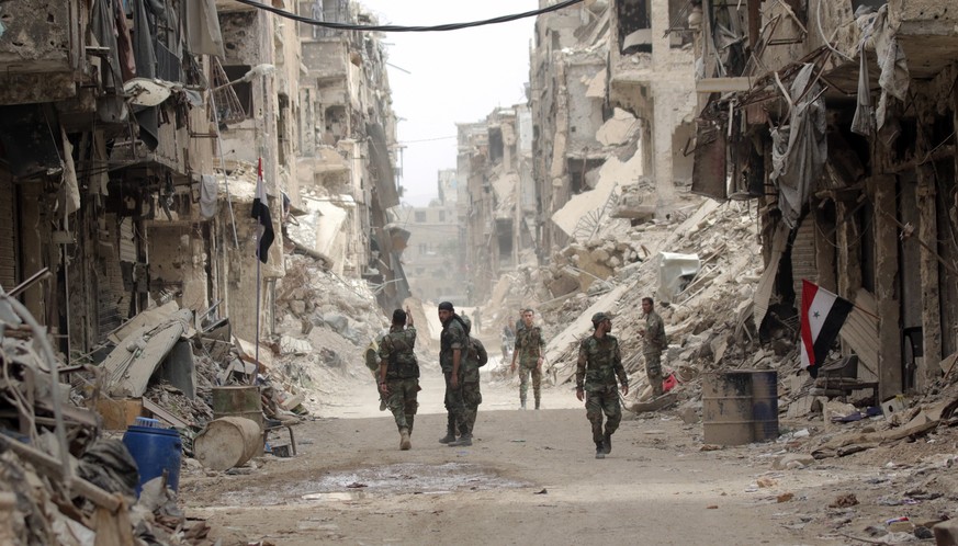 epaselect epa06755964 Syrian soldiers patrol at the Yarmouk Camp district in south Damascus, Syria, 22 May 2018. Media reports state the Syrian government of Bashar al-Assad on 21 May recaptured the l ...