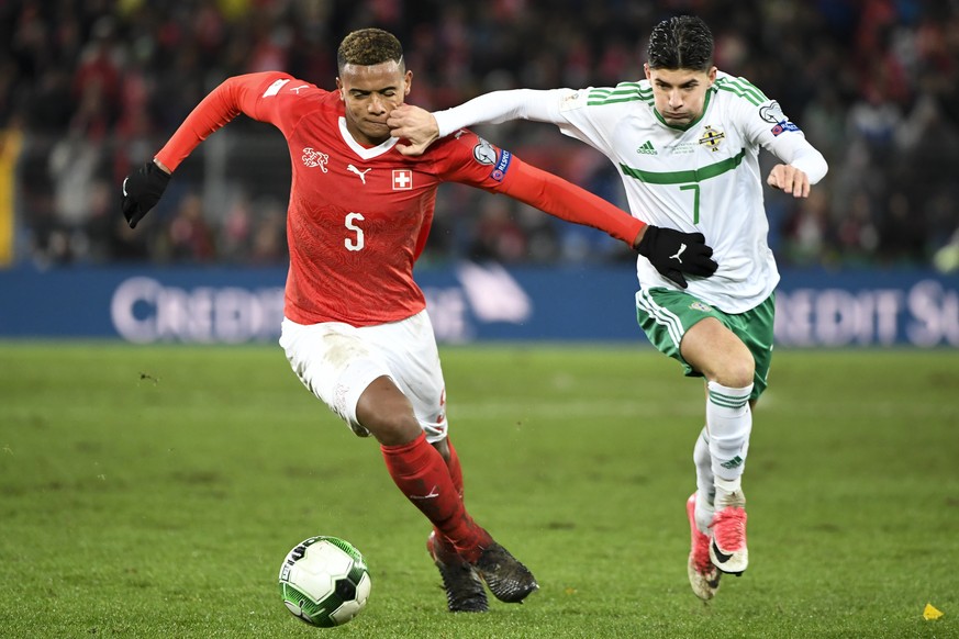 Switzerland&#039;s defender Manuel Akanji, left, fights for the ball with Northern Ireland&#039;s midfielder Jordan Jones, right, during the 2018 Fifa World Cup play-offs second leg soccer match Switz ...