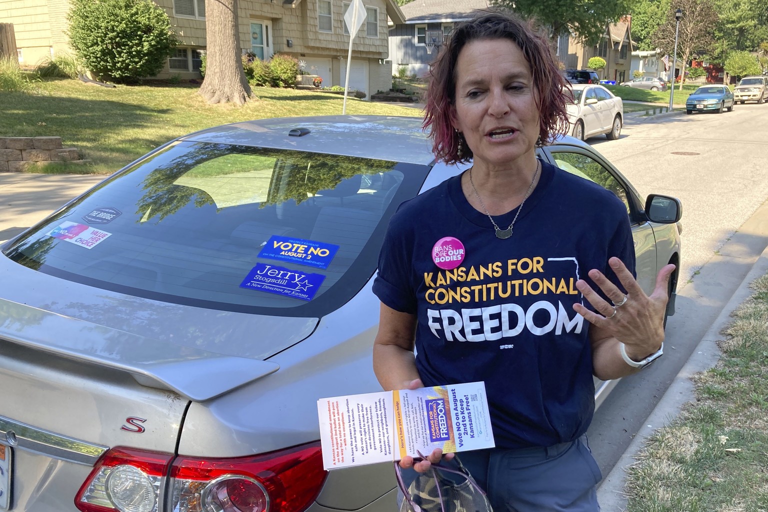 FILE - Anne Melia discusses her opposition to a proposed amendment to the Kansas Constitution that would allow legislators to further restrict or ban abortion on July 14, 2022, before she goes door-to ...