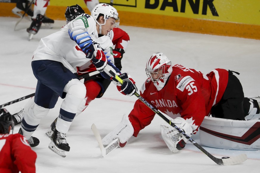 epa09223883 Goalkeeper Darcy Kuemper of Canada in action against Jason Robertson (L) of USA during the IIHF 2021 World Ice Hockey Championships group B match between Canada and USA at the Arena Riga,  ...