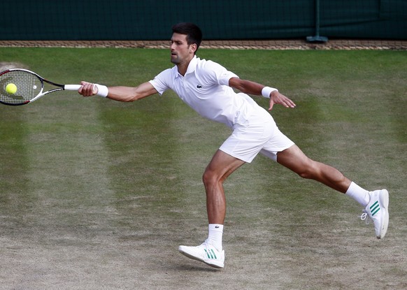 epa06083577 Novak Djokovic of Serbia serves to Tomas Berdych of the Czech Republic in their quarter final match during the Wimbledon Championships at the All England Lawn Tennis Club, in London, Brita ...