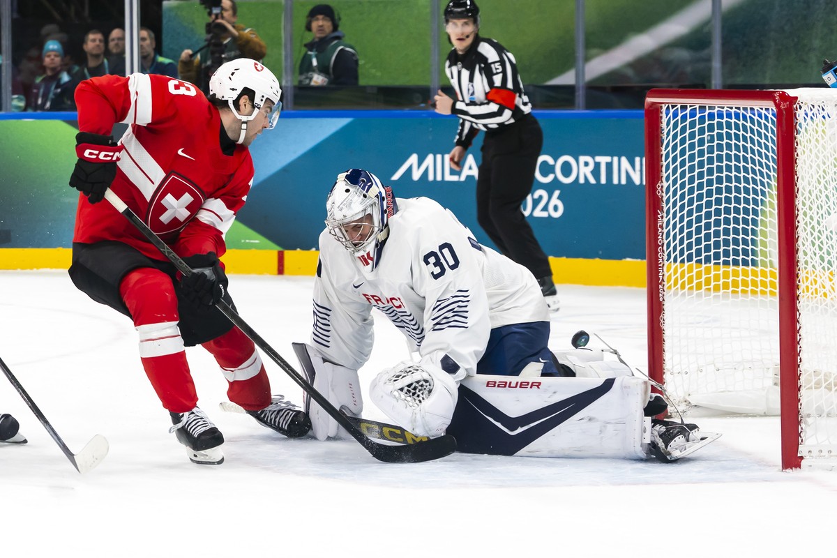 Switzerland's Nico Hischier #13, misses a scoring goal against France's goaltender Antoine Keller #30, during the men's group A preliminary round game between Switzerland and France at  ...
