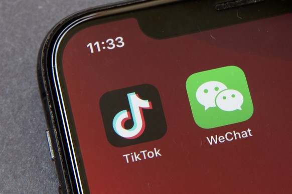 Icons for the smartphone apps TikTok and WeChat are seen on a smartphone screen in Beijing, Friday, Aug. 7, 2020. President Donald Trump has ordered a sweeping but unspecified ban on dealings with the ...