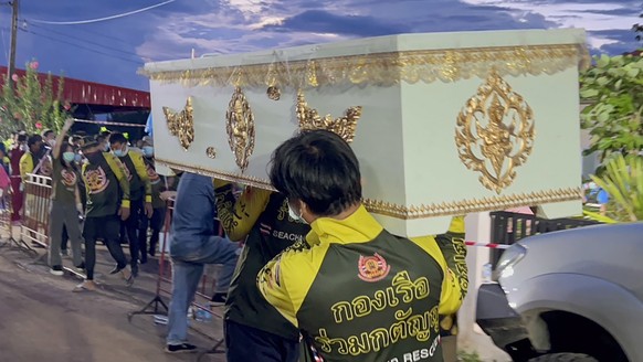 epa10226541 A handout photo made available by Ruamkatanyu Foundation shows Ruamkatanyu Foundation's rescue workers carrying a coffin for the mass shooting victims at a childcare center in Nong Bua Lam ...