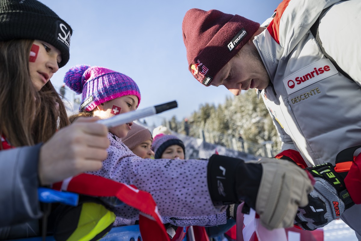 Marco Odermatt of Switzerland gives autographs to fans in the finish area after a training session for the men's Downhill race at the Alpine Skiing FIS Ski World Cup, in Crans-Montana, Switzerlan ...