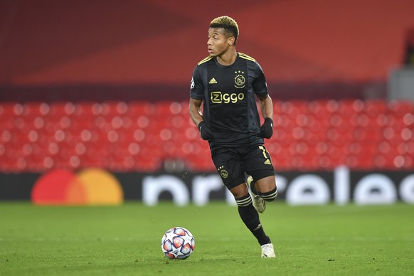 Ajax&#039;s David Neres runs with the ball during the Champions League group D soccer match between Liverpool and Ajax at Anfield stadium in Liverpool, England, Tuesday, Dec. 1, 2020. (Paul Ellis/Pool ...