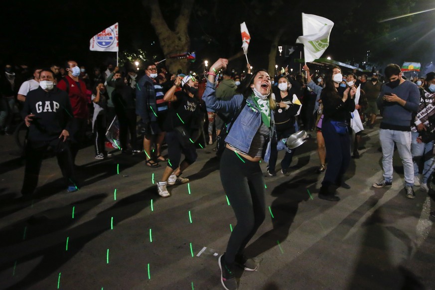 People gather at Plaza Italia on the day Chileans voted in a referendum to decide whether the country should replace its 40-year-old constitution, written during the dictatorship of Gen. Augusto Pinoc ...