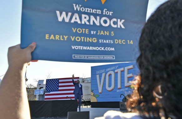 epa08919498 Supporters as Rev. Raphael Warnock waves at an event featuriing President-elect Joe Biden appearing during a campaign rally for Democrats Jon Ossoff and Warnock at the Georgia State Univer ...