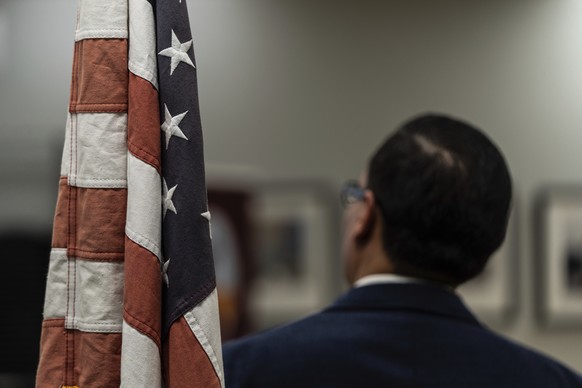 Winston Leiva, community education programs manager at the Coalition for Humane Immigrant Rights, stands next to a U.S. flag while giving a bilingual workshop for immigrants who want to stay in the Un ...