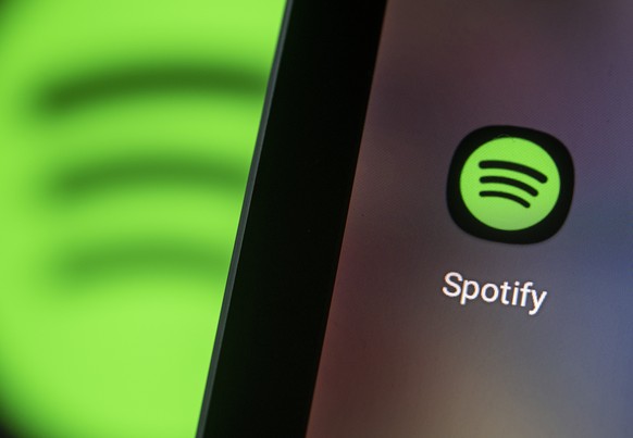 ARCHIVE - April 28, 2021, Berlin: The logo of the Spotify app can be seen on a smartphone screen.  (to dpa