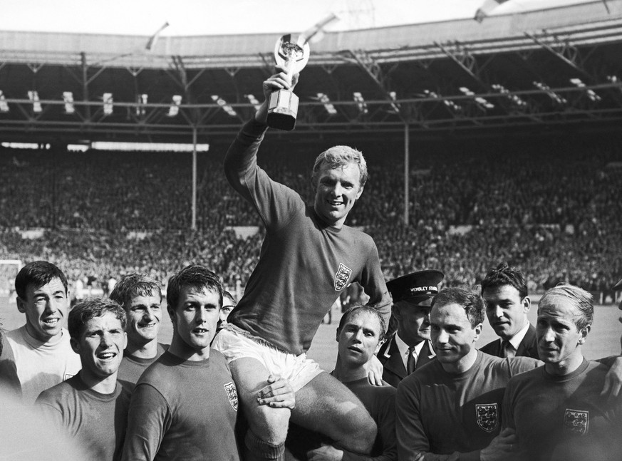 FILE - IIn this July 30, 1966 file photo England&#039;s soccer team captain Bobby Moore, is carried shoulder high by his teammates holding World Cup on July 30, 1966. England defeated West Germany 4-2 ...