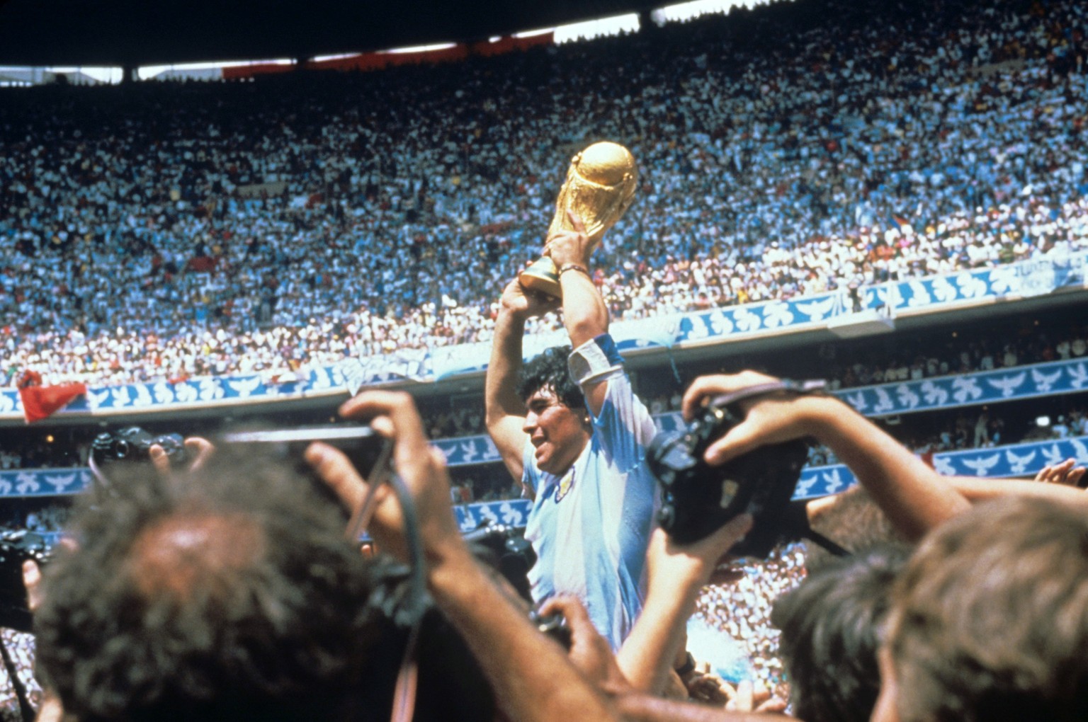epa08841584 (FILE) - Argentinian soccer legend Diego Armando Maradona lifts the FIFA World Cup trophy after defeating Germany at the Azteca stadium in Mexico City, Mexico, 29 June 1986 (re-issued on 2 ...