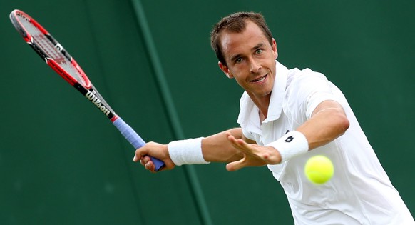 epa04828371 Lukas Rosol of the Czech Republic in action against Pablo Andujar of Spain during their second round match for the Wimbledon Championships at the All England Lawn Tennis Club, in London, B ...