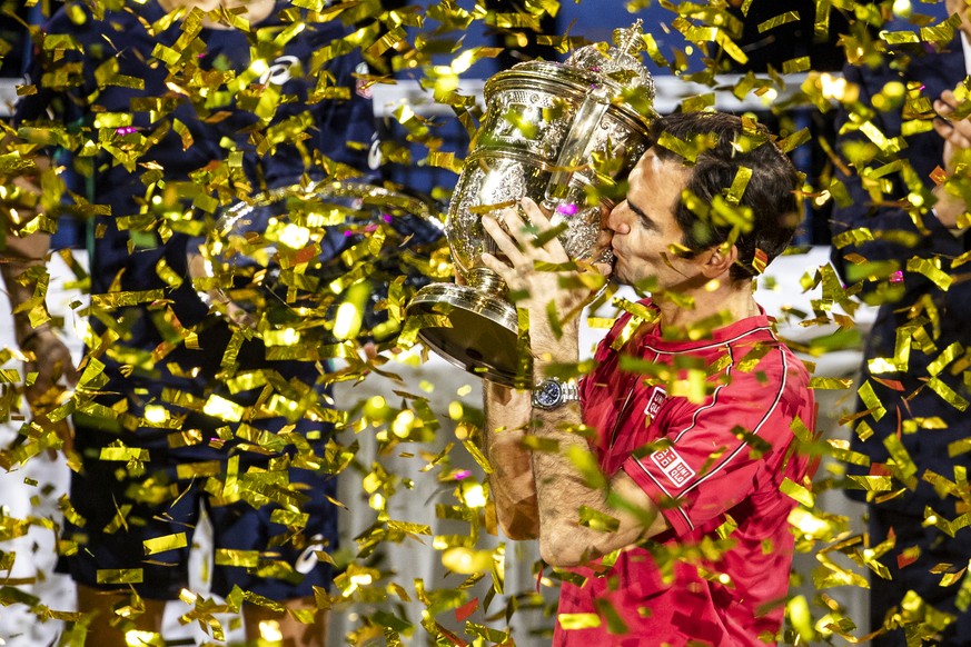 Roger Federer of Switzerland poses with his trophy after defeating Alex De Minaur of Australia after the final match at the Swiss Indoors tennis tournament at the St. Jakobshalle in Basel, Switzerland ...