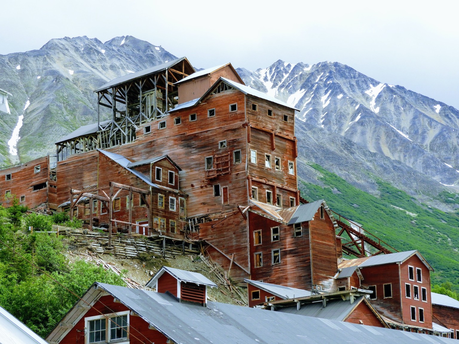 McCarthy, Alaska, July, 2019, view of abandoned Kennecott copper mine with mountains in the background.