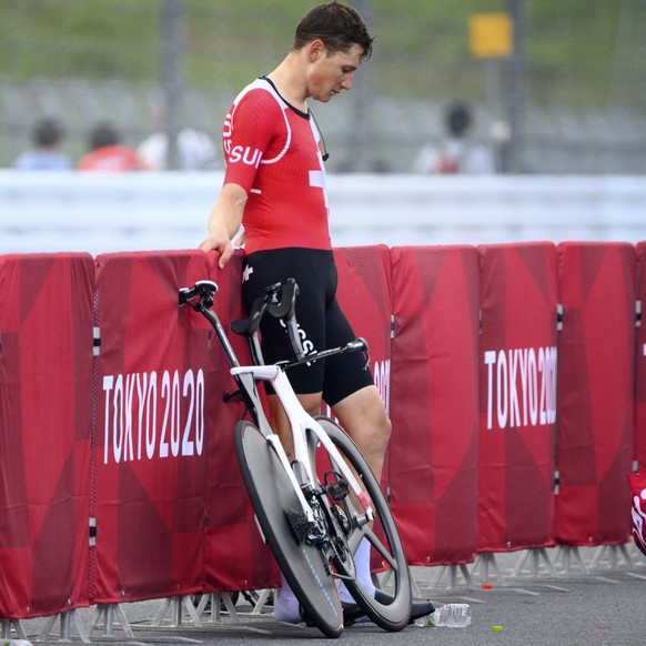 Fourth placed Stefan Kueng of Switzerland reacts after crossing the finish line during the men's cycling individual time trial at the 2020 Tokyo Summer Olympics at the Fuji International Speedway ...