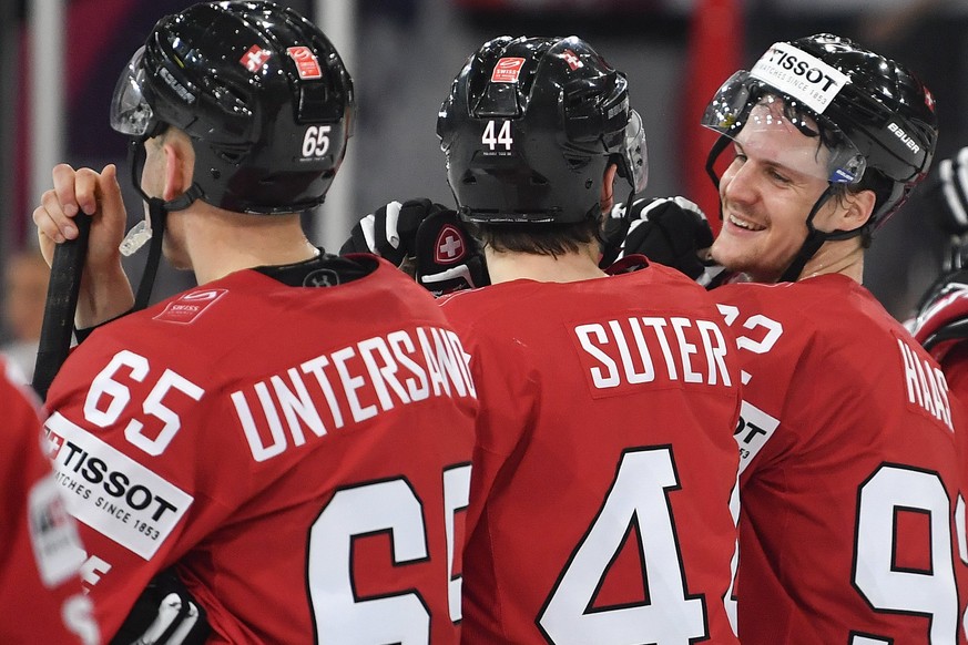 epa05955259 (L-R) Switzerland&#039;s Ramon Untersander, Pius Suter and Gaetan Haas react after the 2017 IIHF Ice Hockey World Championship group B preliminary round match between Switzerland and Belar ...