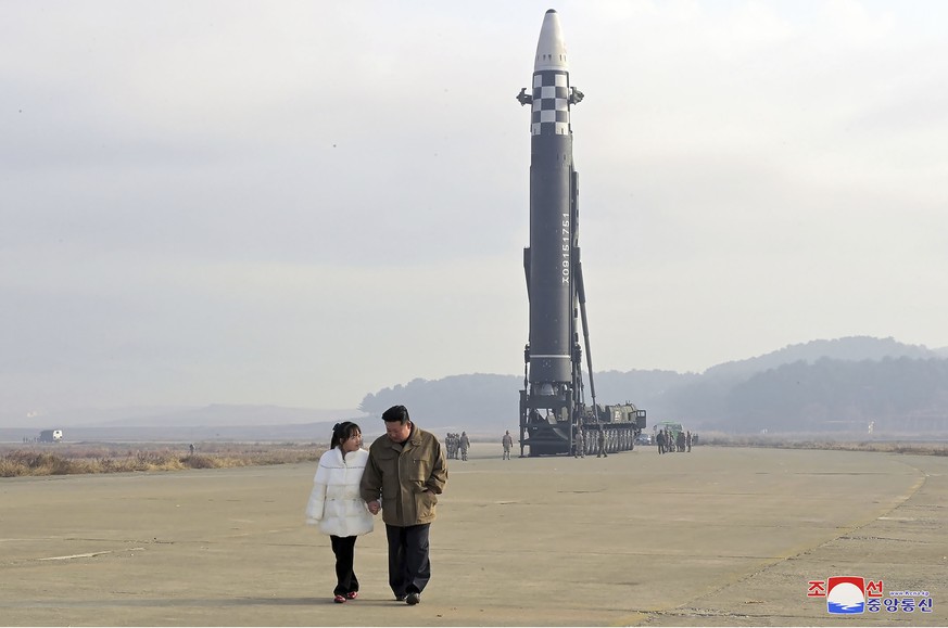 FILE - This photo, provided on Nov. 19, 2022, by the North Korean government, shows North Korean leader Kim Jong Un, right, and his daughter at the site of a missile launch at Pyongyang International Ai...