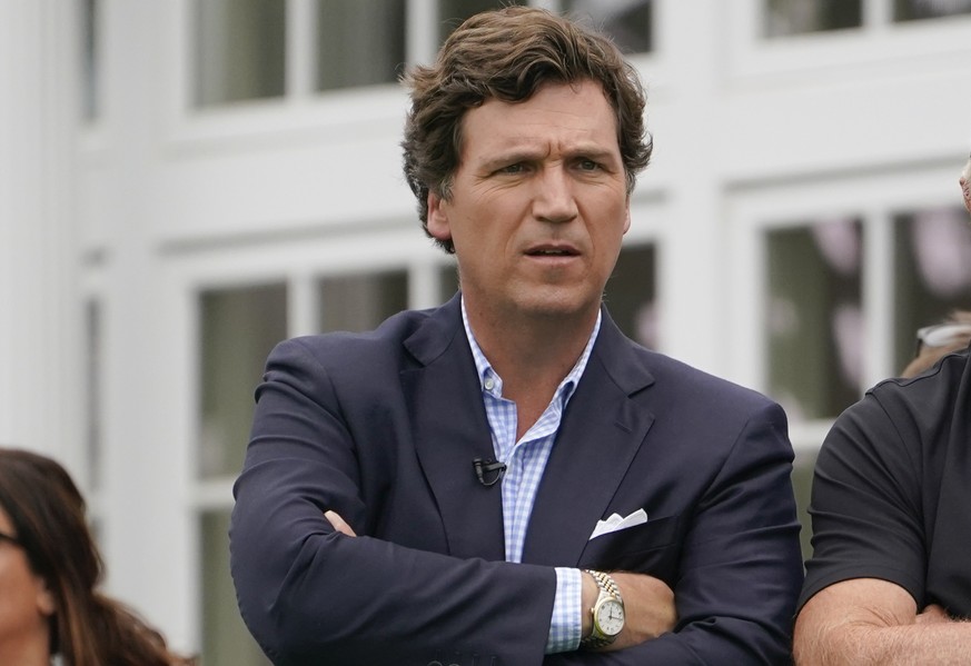 FILE - Tucker Carlson attends the final round of the Bedminster Invitational LIV Golf tournament in Bedminster, N.J., Sunday, July 31, 2022. Fox News says it has agreed to part ways with Tucker Carlso ...