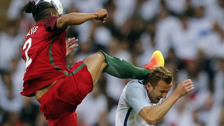 Portugal&#039;s Bruno Alves, left, fouls England&#039;s Harry Kane during the International friendly soccer match between England and Portugal at Wembley stadium in London, England, Thursday, June 2,  ...