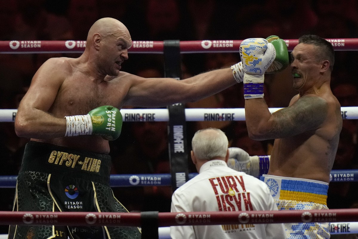 Britain's Tyson Fury, left, punches Ukraine's Oleksandr Usyk during their undisputed heavyweight world championship boxing fight at the Kingdom Arena in Riyadh, Saudi Arabia, Sunday, May 19, ...