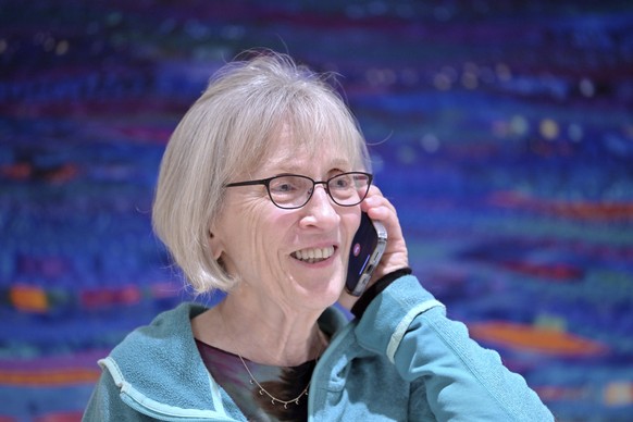 Claudia Goldin speaks to a reporter on the phone in her home in Cambridge, Mass. after learning that she received the Nobel Prize in Economics, Monday, Oct. 9, 2023. The Nobel Prize in Economic Scienc ...