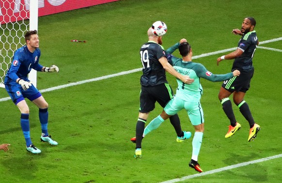 epa05411439 Cristiano Ronaldo (2-R) of Portugal in action against James Collins (2-L) of Wales during the UEFA EURO 2016 semi final match between Portugal and Wales at Stade de Lyon in Lyon, France, 0 ...