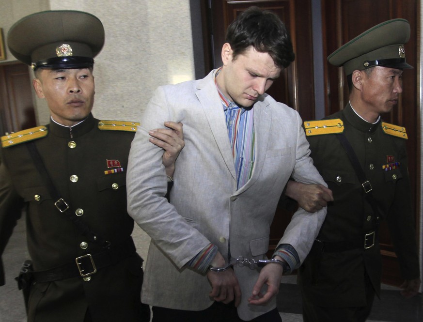 FILE - In this March 16, 2016, file photo, American student Otto Warmbier, center, is escorted at the Supreme Court in Pyongyang, North Korea. North Korea on Friday, Nov. 16, 2018, said it is expellin ...