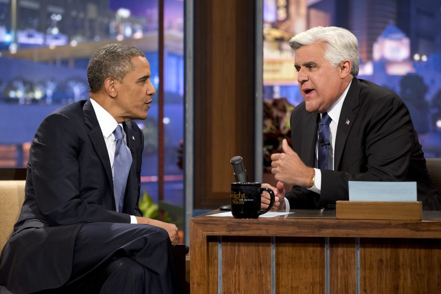 FILE - In this Aug. 6, 2013 file photo, President Barack Obama, left, talks with Jay Leno during a commercial break during the taping of his appearance on &quot;The Tonight Show with Jay Leno&quot; in ...