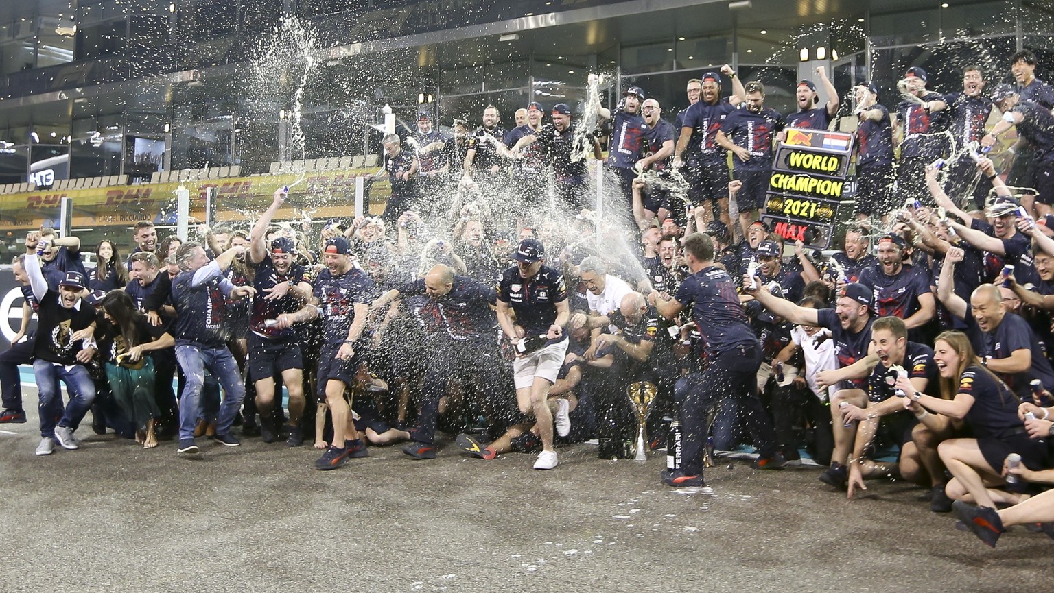 epa09639191 Dutch Formula One driver Max Verstappen of Red Bull Racing (C) celebrates with team members after winning the 2021 Formula One Grand Prix of Abu Dhabi at Yas Marina Circuit in Abu Dhabi, U ...