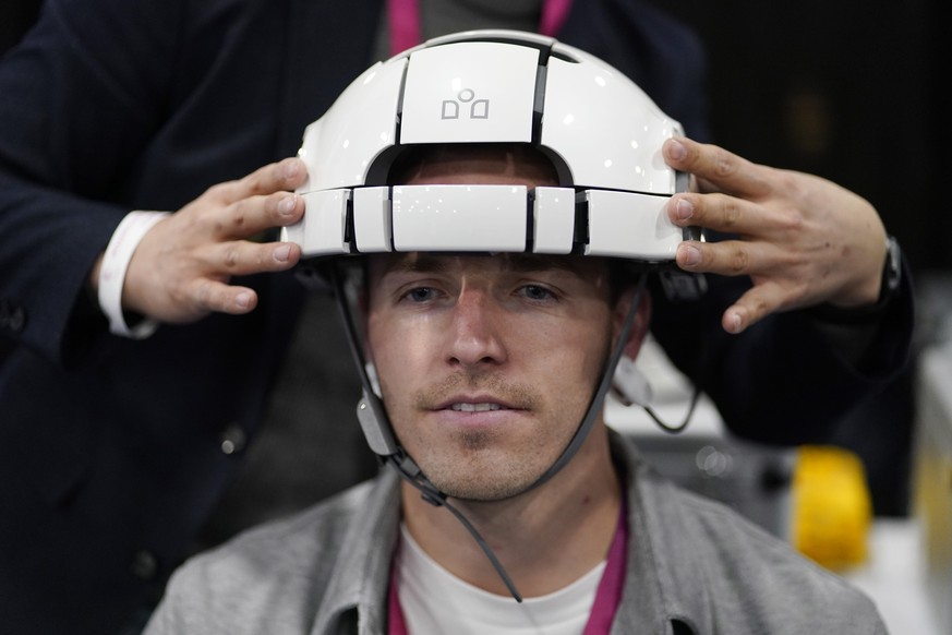 An attendee tries out a iMediSync iSyncWave portable wireless EEG brain scanner during CES Unveiled before the start of the CES tech show, Tuesday, Jan. 3, 2023, in Las Vegas. (AP Photo/John Locher)