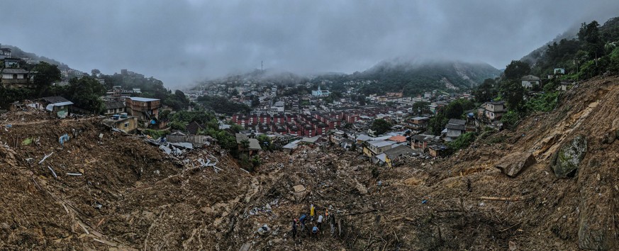 epa09770275 A photograph taken with a drone shows a general view of the destruction after heavy rains on 15 February in Morro de la Oficina, in the city of Petropolis, state of Rio de Janeiro, Brazil, ...