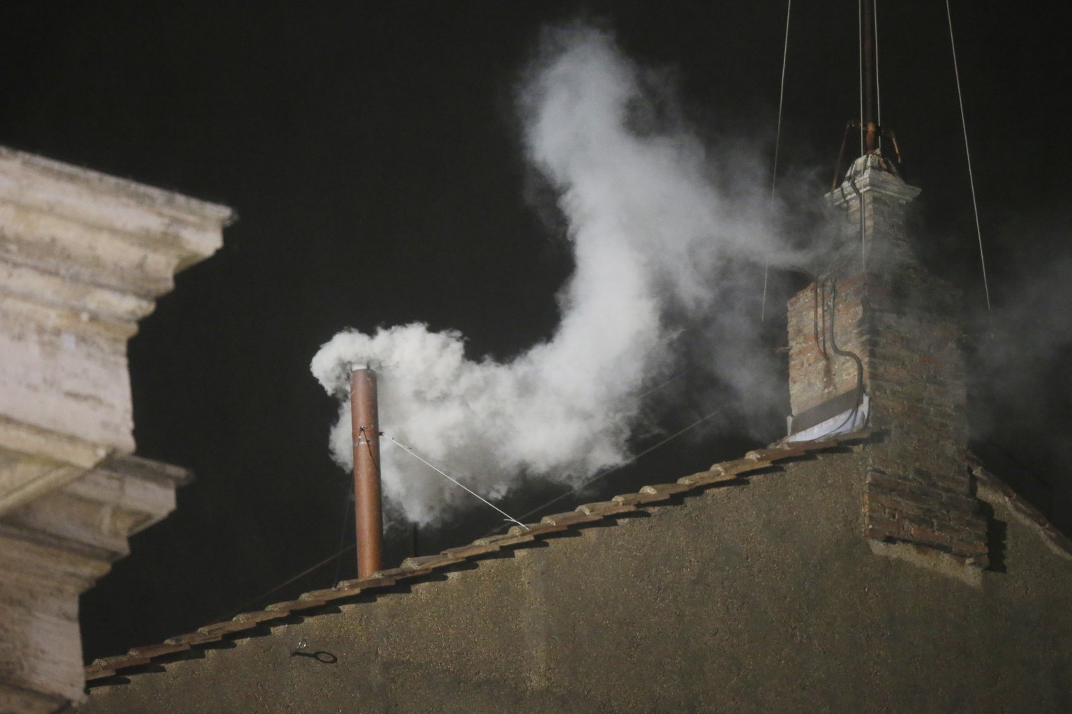 FILE - White smoke is seen billowing out from the chimney of the Sistine Chapel and announcing that a new pope has been elected on Wednesday, March 13, 2013. (AP Photo/Gregorio Borgia, File)
Vatican O ...