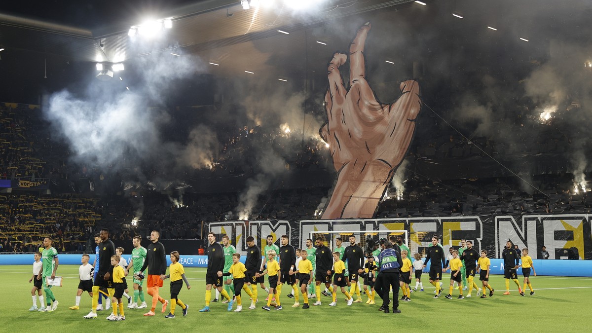 The teams arrive on the pitch prior to the UEFA Champions League Play-offs 2nd leg match between Switzerland's BSC Young Boys and Israel's Maccabi Haifa, at the Wankdorf stadium, in Berne, S ...