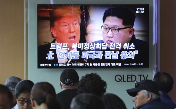 People watch a TV screen showing images of U.S. President Donald Trump, left, and North Korean leader Kim Jong Un during a news program at the Seoul Railway Station in Seoul, South Korea, Friday, May  ...