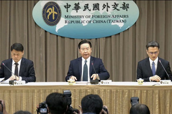 In this image from video released by Taiwan Ministry of Foreign Affairs Office, Taiwan Foreign Minister Joseph Wu, center, prepares to speak at a press conference after Honduras announced severance of ...