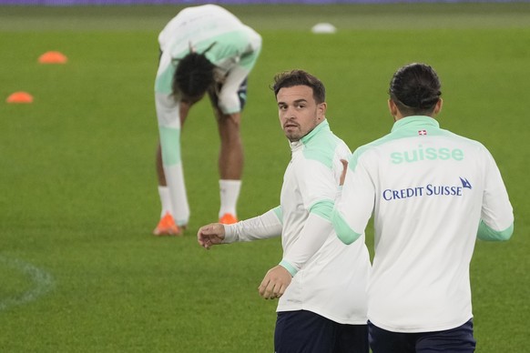 Switzerland&#039;s Xherdan Shaqiri, left, talks with teammate Ricardo Rodriguez during a training session ahead of the World Cup 2022 group C qualifying soccer match between Italy and Switzerland at R ...