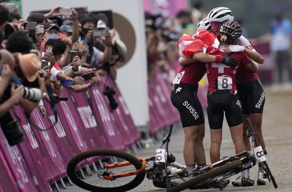 Jolanda Neff of Switzerland hugs teammates Sina Frei (8) who won silver, and Linda Indergand (19) who won bronze, for a sweep of the podium for Switzerland, at the finish line the women&#039;s cross-c ...