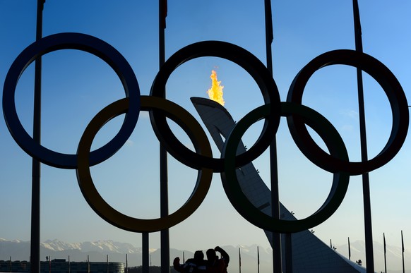 The Olympic Flame is on on the top of the Olympic cauldron trought the Olympic Rings in the Olympic Park during the XXII Winter Olympics 2014 Sochi, in Sochi, Russia, on Saturday, February 8, 2014. (K ...