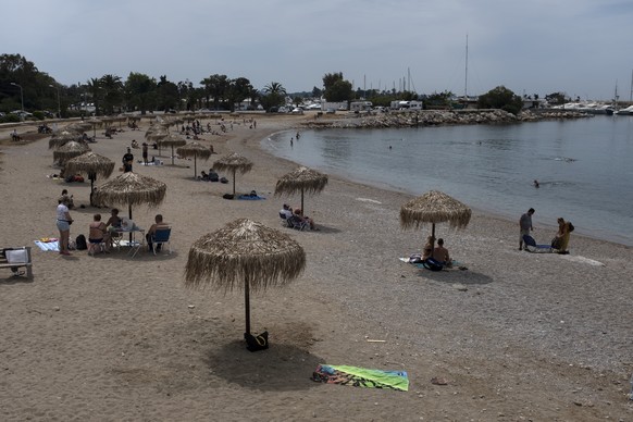 FILE - In this Sunday, May 10, 2020 file photo, people enjoy the beach of Glyfada suburb, southwest of Athens. Greece&#039;s Prime Minister Kyriakos Mitsotakis said Wednesday April 21, 2021, the count ...